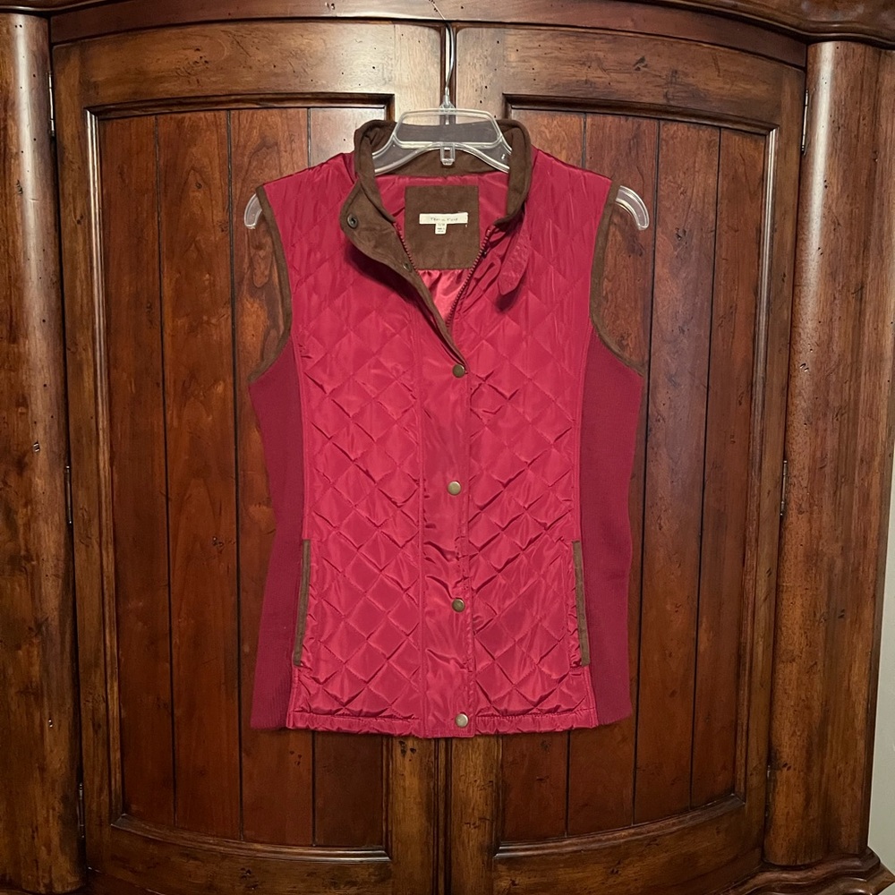 Vest with faux suede trim   Zipper and snap front side pockets.